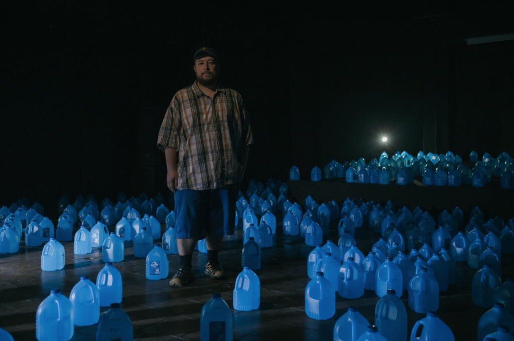 Lenca rodeado de botellas de plástico